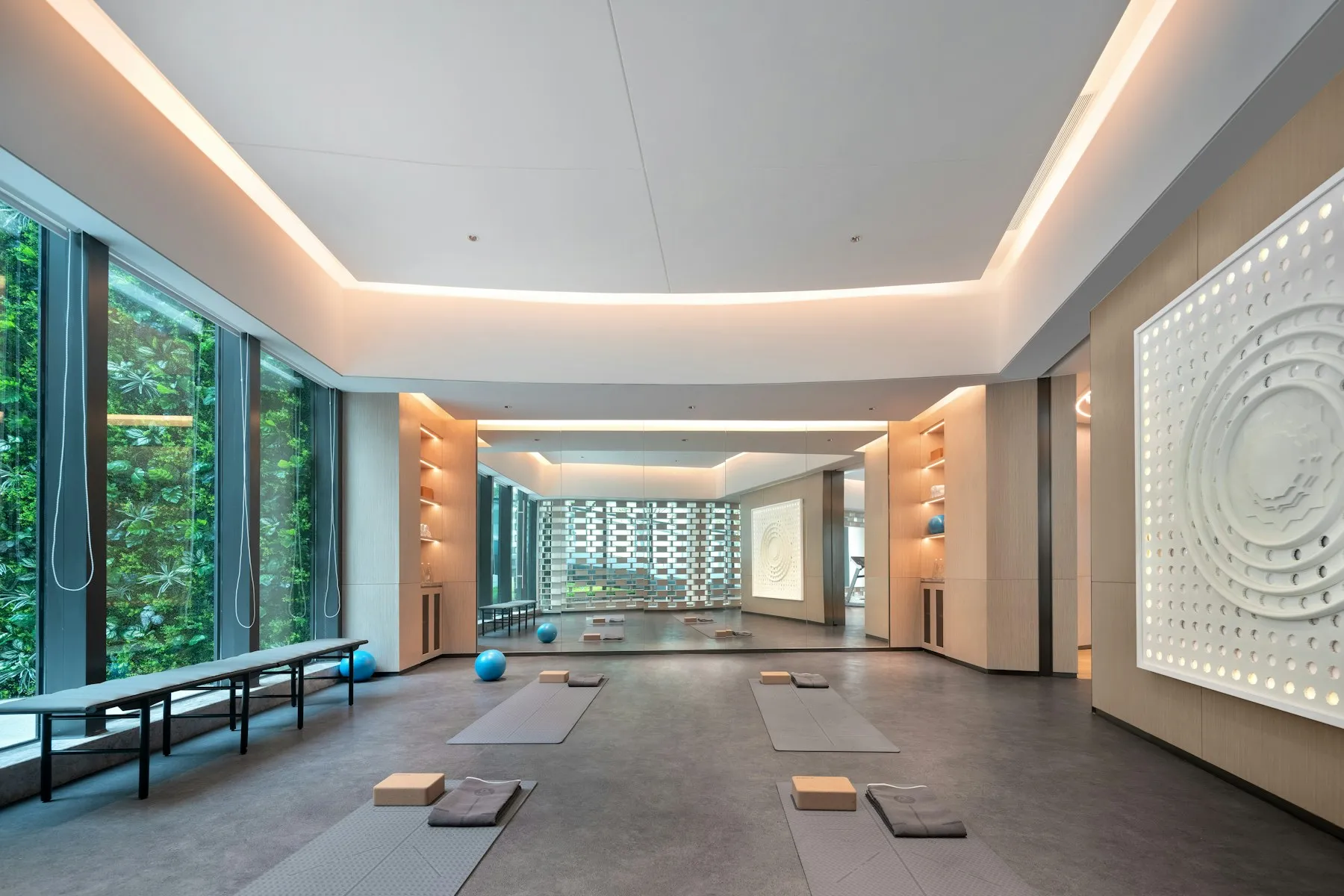 A bright, empty studio room with mats laid out